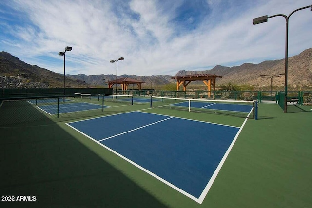 view of sport court featuring basketball court, a gazebo, and a mountain view