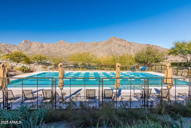 view of swimming pool with a patio area and a mountain view