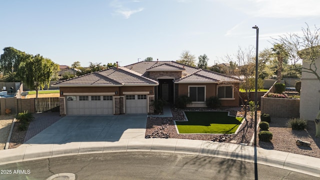 view of front of property featuring concrete driveway, stone siding, a tiled roof, an attached garage, and fence