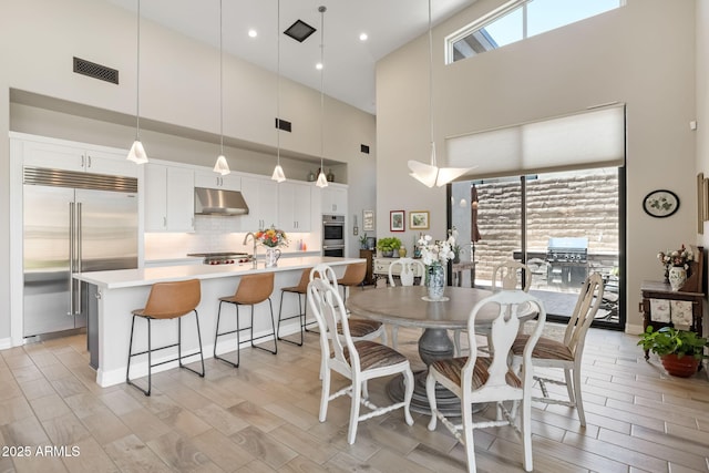 14507 N Valencia Dr, Fountain Hills, AZ 85268 - dining space with a towering ceiling and light wood-style floors