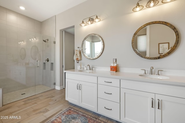 14507 N Valencia Dr, Fountain Hills, AZ 85268 - bathroom featuring double vanity, a stall shower, wood finished floors, and recessed lighting