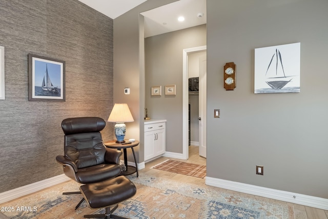 14507 N Valencia Dr, Fountain Hills, AZ 85268 - living area featuring baseboards, an accent wall, and light wood finished floors