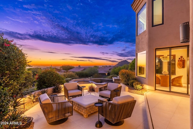 patio terrace at dusk featuring outdoor lounge area