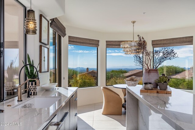 interior space featuring an inviting chandelier, a mountain view, and sink