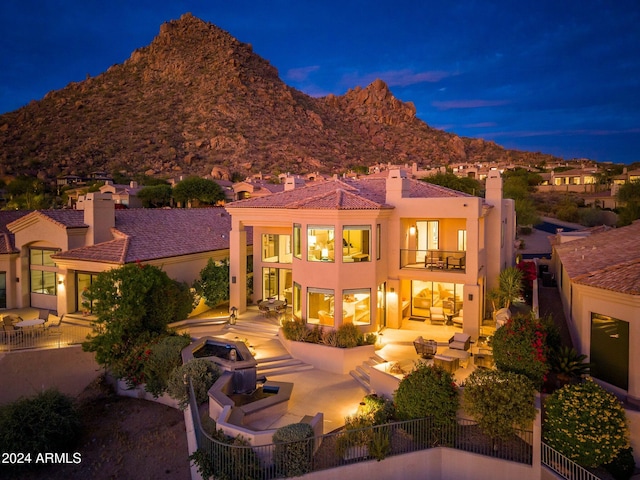 rear view of house featuring a balcony, outdoor lounge area, and a patio