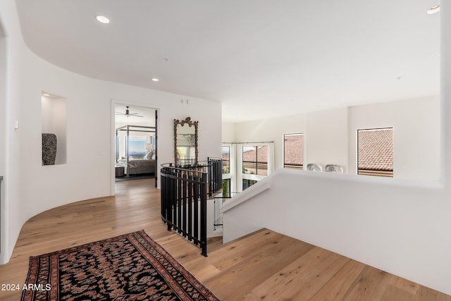 corridor with hardwood / wood-style flooring