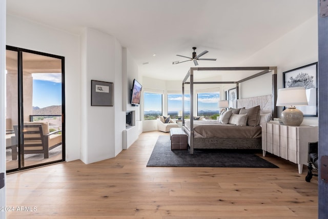 bedroom featuring access to exterior and light hardwood / wood-style flooring