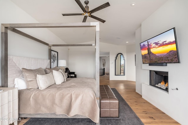 bedroom featuring hardwood / wood-style floors and vaulted ceiling