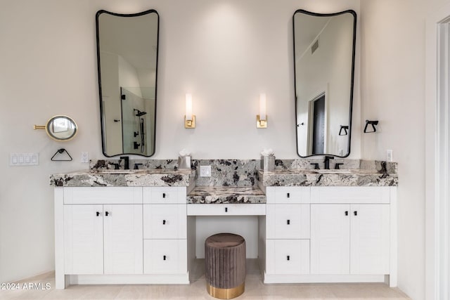 bathroom with vanity and a shower with shower door