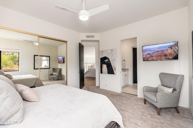 carpeted bedroom with connected bathroom, a closet, and ceiling fan