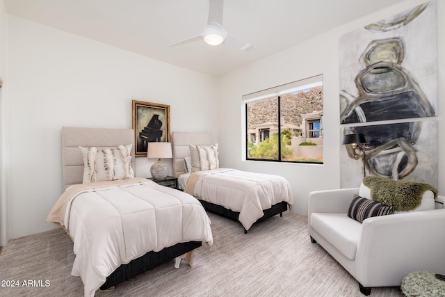 bedroom featuring ceiling fan and light carpet