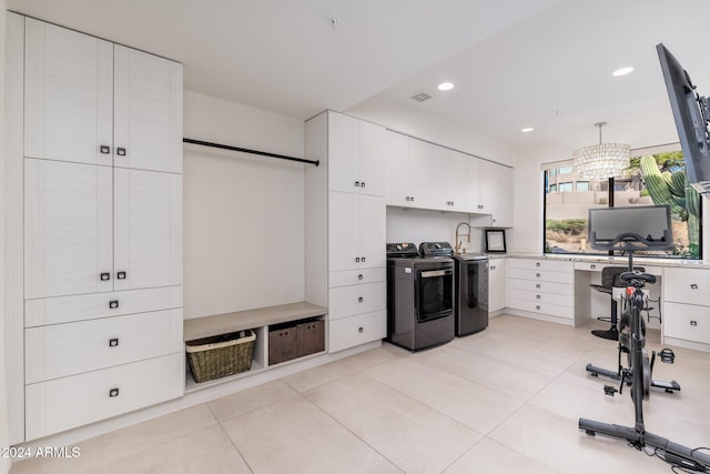 kitchen featuring white cabinetry, washer and dryer, pendant lighting, and light tile patterned flooring