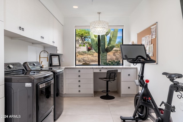 laundry area featuring cabinets, light tile patterned floors, a notable chandelier, and independent washer and dryer