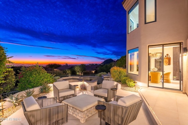 patio terrace at dusk with an outdoor living space