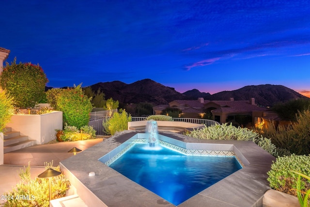 pool at dusk with a mountain view