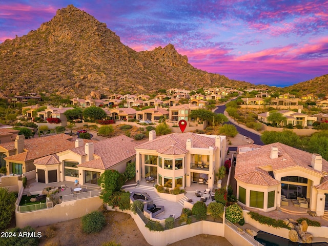 aerial view at dusk featuring a mountain view