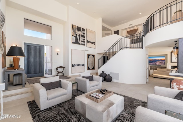 tiled living room featuring a high ceiling