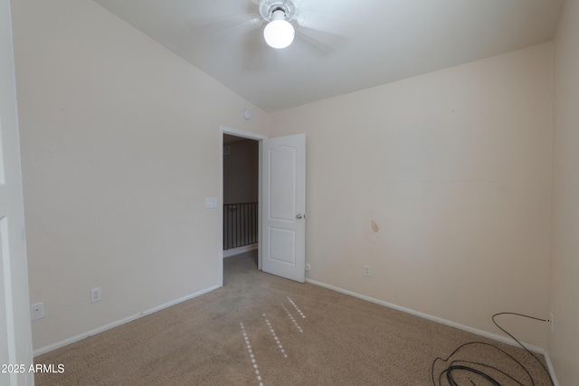 unfurnished room with light colored carpet and vaulted ceiling