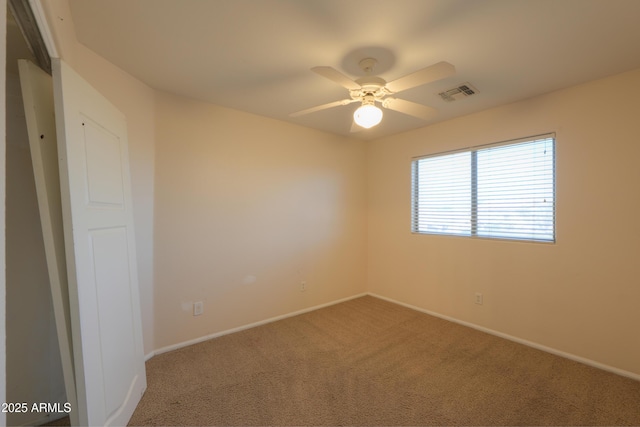 unfurnished room with carpet floors and ceiling fan