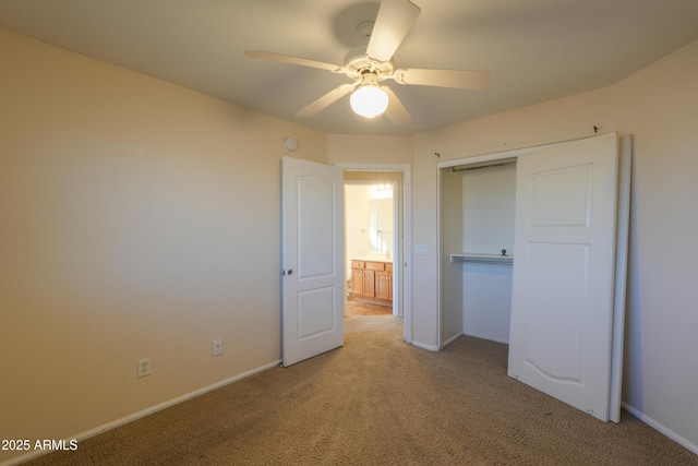 unfurnished bedroom featuring ceiling fan, light colored carpet, and a closet