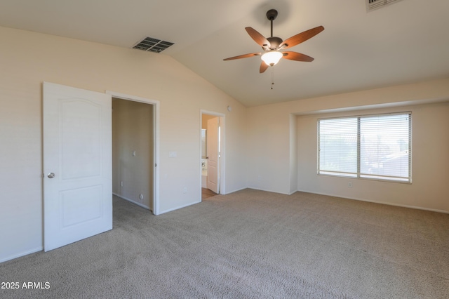 unfurnished bedroom with ceiling fan, light carpet, vaulted ceiling, and connected bathroom