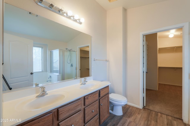 full bathroom with toilet, wood-type flooring, vaulted ceiling, shower with separate bathtub, and vanity