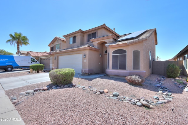 view of front of home with a garage and solar panels