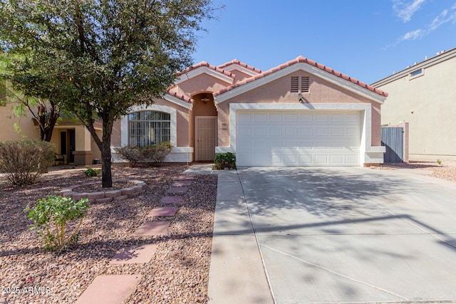 view of front of home featuring a garage, concrete driveway, a tiled roof, and stucco siding