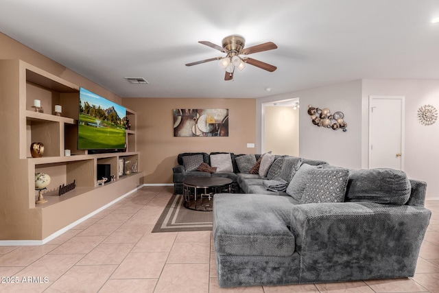 living room featuring light tile patterned floors, visible vents, baseboards, ceiling fan, and built in shelves