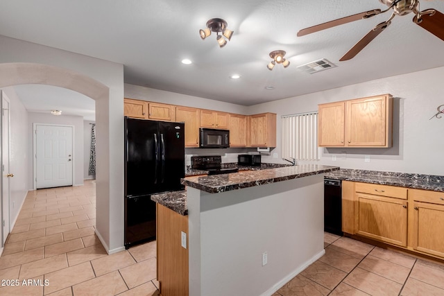 kitchen with arched walkways, light tile patterned flooring, visible vents, a center island, and black appliances