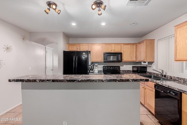 kitchen with black appliances, light brown cabinetry, and a center island