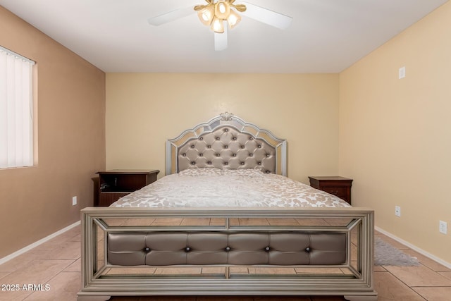 bedroom with ceiling fan, baseboards, and light tile patterned floors