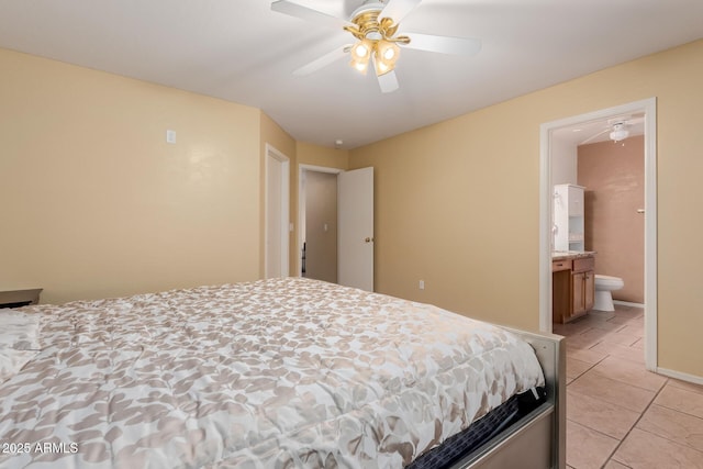 bedroom featuring light tile patterned floors, ensuite bath, a ceiling fan, and baseboards