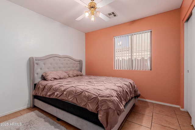 bedroom with baseboards, visible vents, a ceiling fan, and tile patterned floors