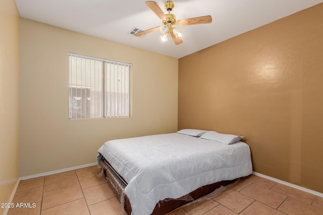 bedroom featuring baseboards, ceiling fan, visible vents, and tile patterned floors