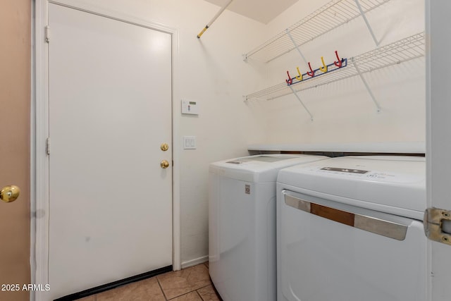 laundry room with laundry area, separate washer and dryer, and light tile patterned flooring