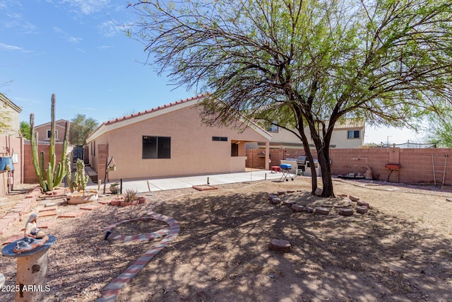 back of house featuring a patio area, a fenced backyard, and stucco siding