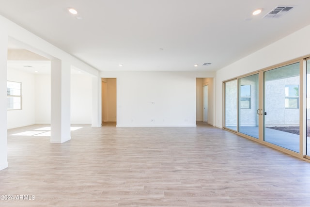 empty room with plenty of natural light and light wood-type flooring