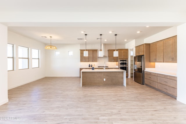 kitchen with a kitchen island with sink, tasteful backsplash, decorative light fixtures, and appliances with stainless steel finishes