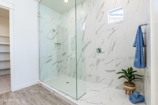 bathroom featuring walk in shower and hardwood / wood-style flooring