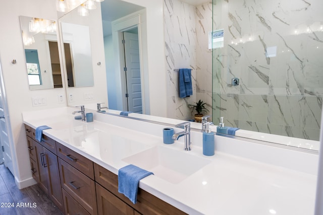 bathroom featuring walk in shower, double sink vanity, and hardwood / wood-style flooring