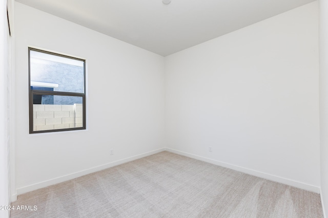 empty room featuring light colored carpet