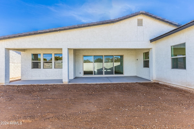 back of house with a patio