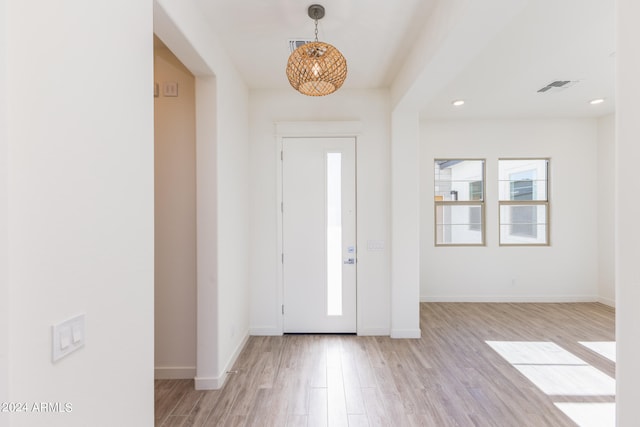 foyer entrance with light hardwood / wood-style floors