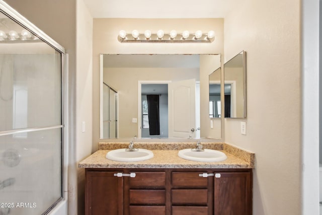 bathroom with vanity and shower / bath combination with glass door