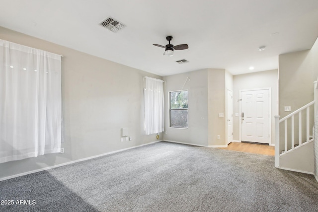 carpeted empty room featuring ceiling fan