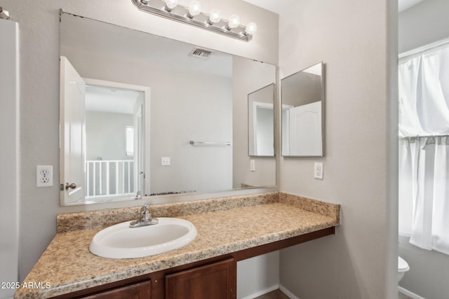 bathroom with vanity and toilet