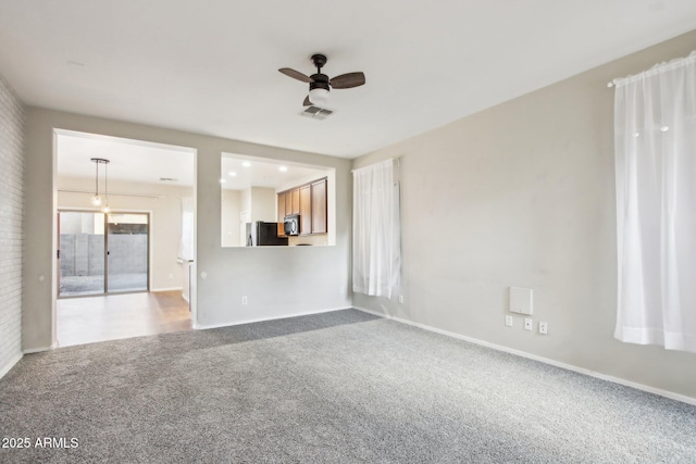 unfurnished living room with ceiling fan and carpet flooring