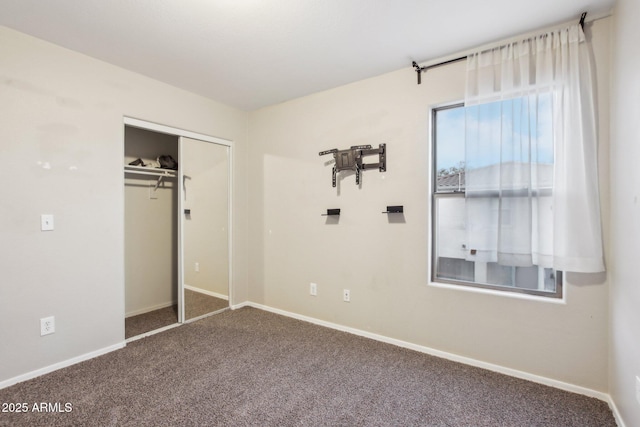 unfurnished bedroom featuring a closet and carpet