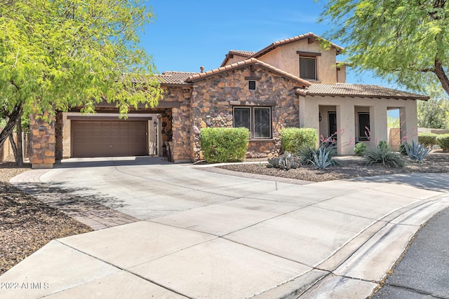 mediterranean / spanish-style home featuring a garage, a tile roof, stone siding, driveway, and stucco siding